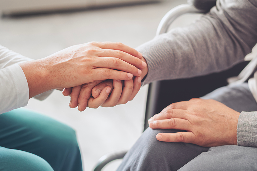 Doctor holding patient hand.